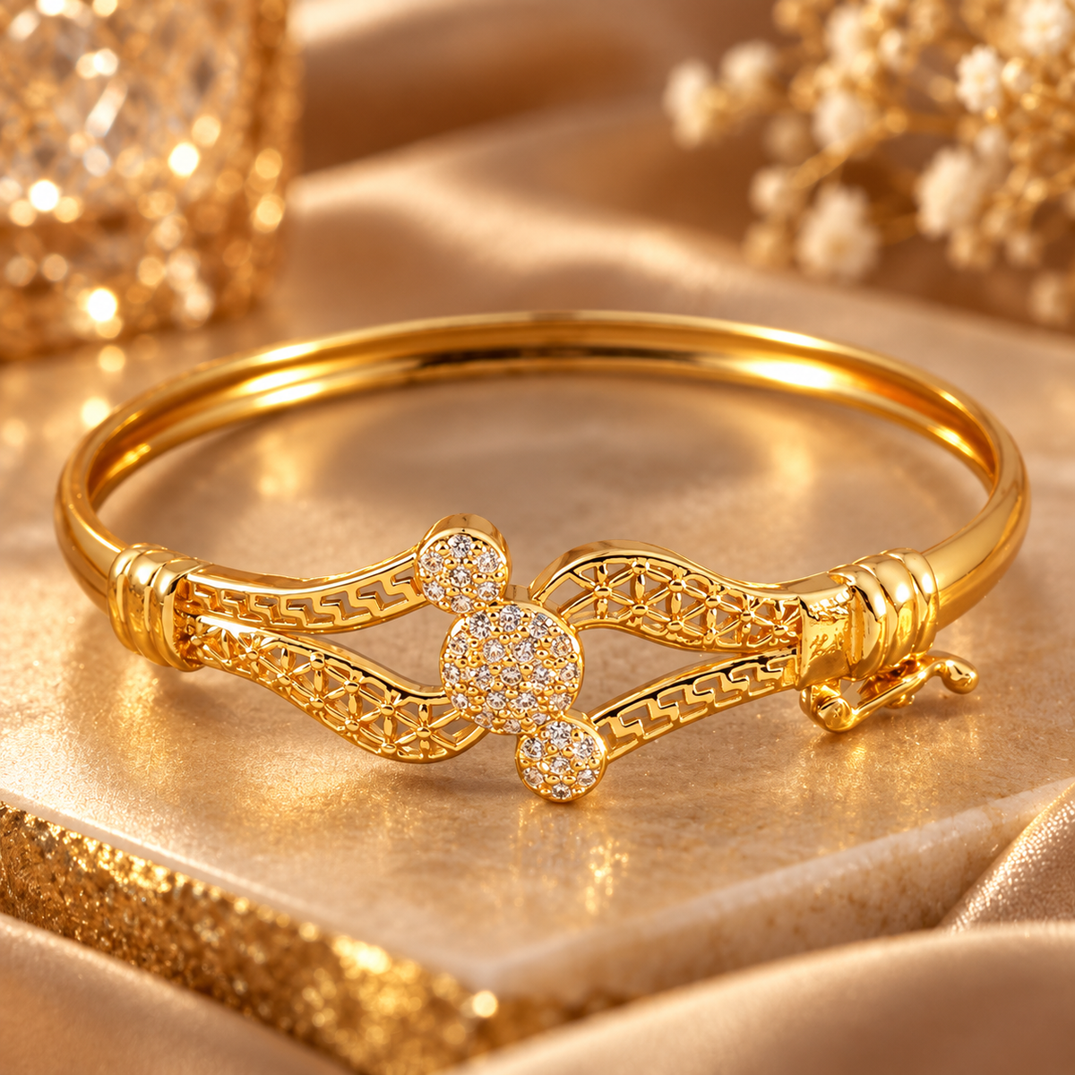 Close-up view of gold tone bracelet showing geometric pattern and decorative crystal details