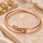 Rose gold geometric cuff bracelet side angle view showing polished titanium steel finish