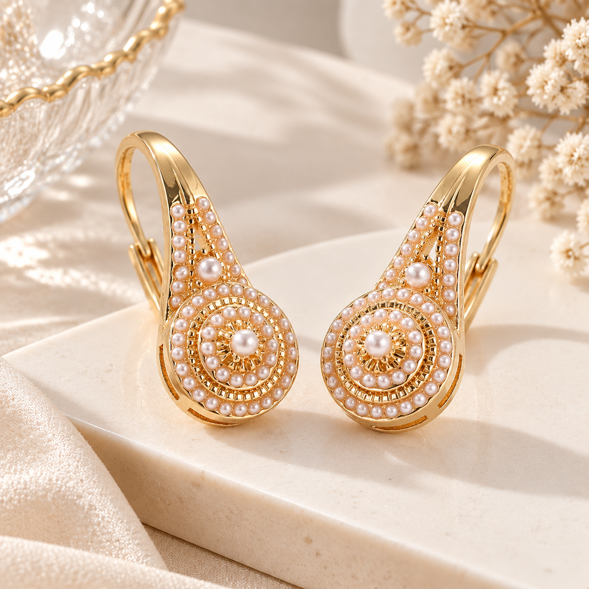Pearl white statement earrings with gold-tone finish in an elegant teardrop design