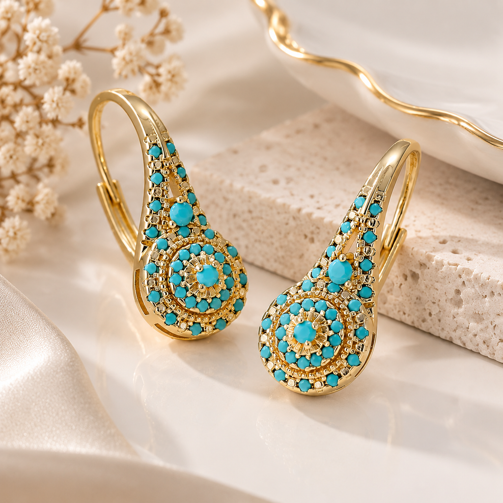 Turquoise crystal drop earrings with gold-tone finish and elegant statement design