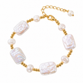 Vintage natural pearl bracelet with gold tone stainless steel chain on white background