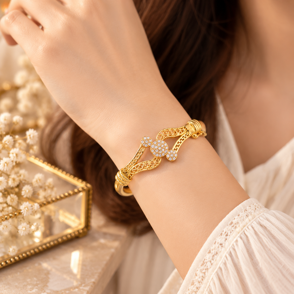 Woman wearing gold tone geometric bracelet with elegant fashion jewelry style