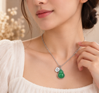 Woman wearing green gourd pendant necklace with elegant silver tone fashion jewelry design