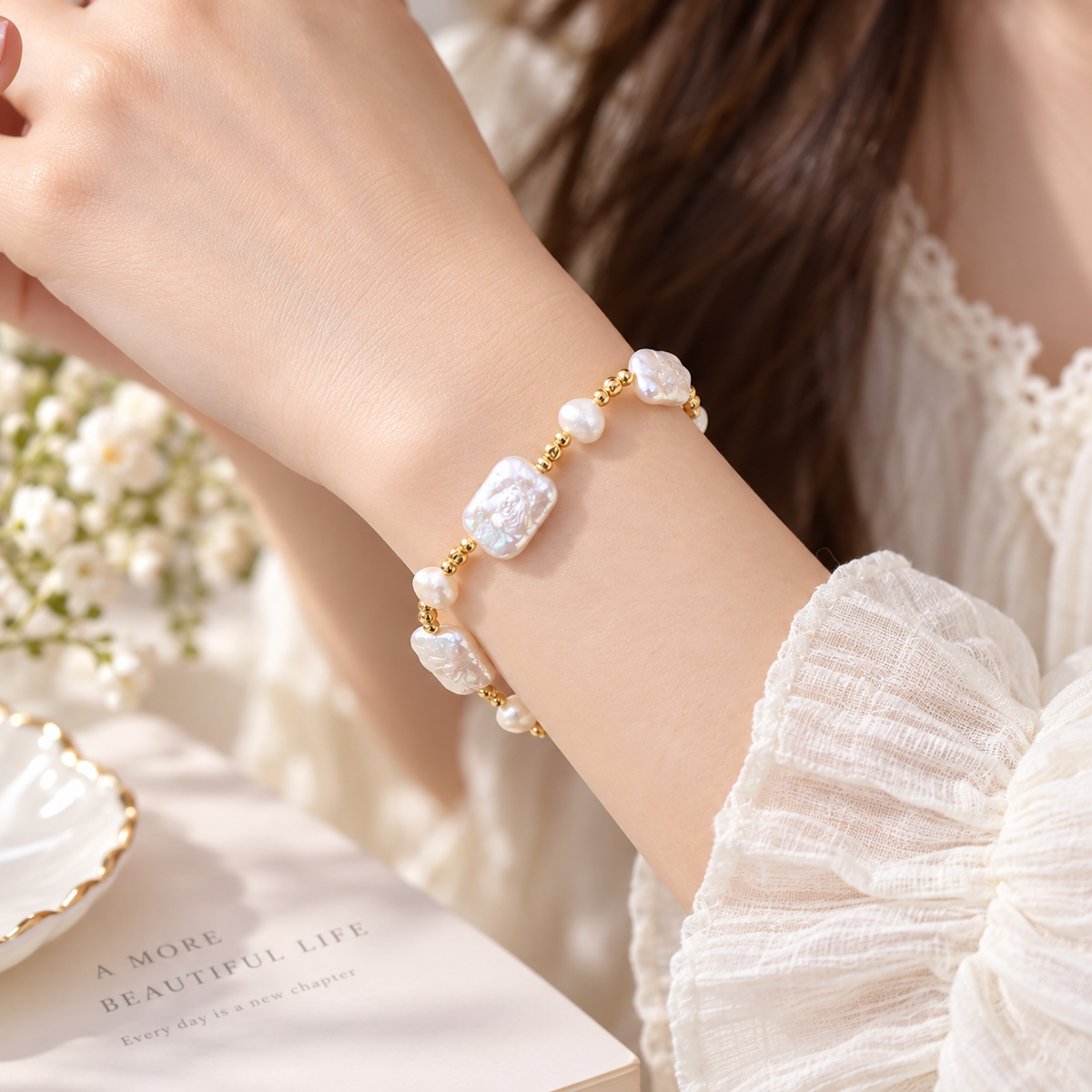 Woman wearing elegant natural pearl bracelet with gold tone jewelry styling